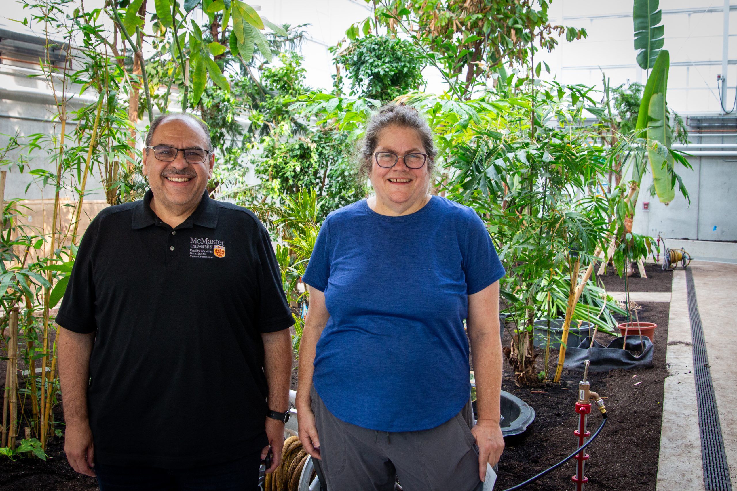 Sam Sargeos and Susan Dudley standing next to each other in the Learning and Discovery Greenhouse